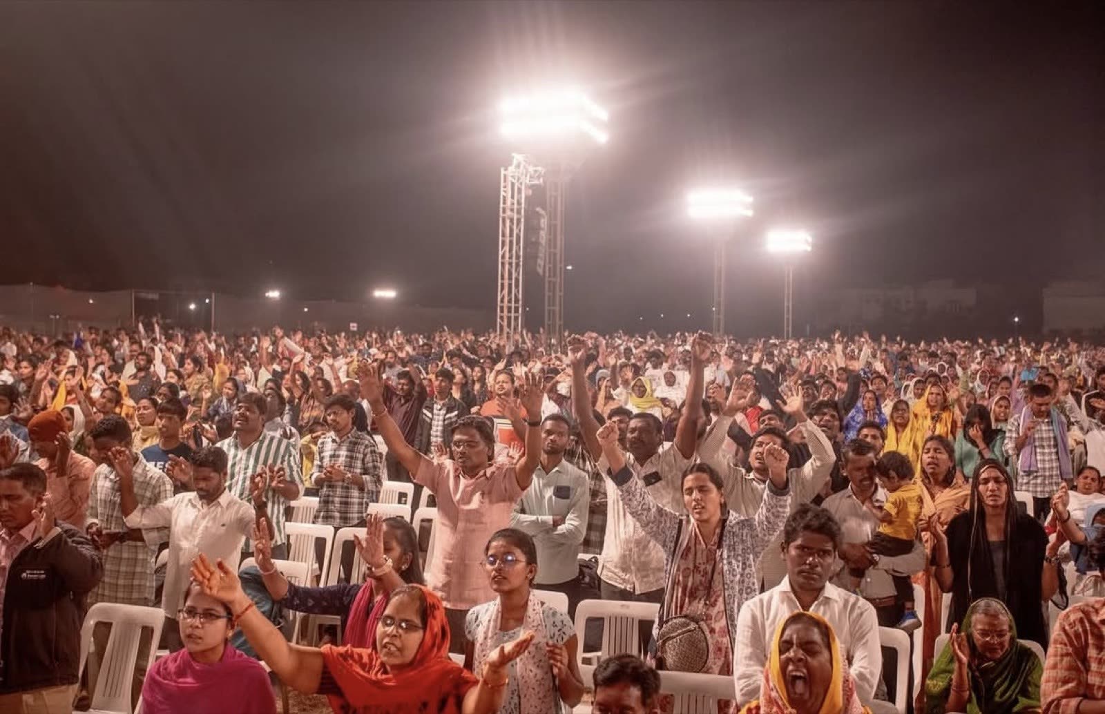 Close view of hands raised in worship and prayer